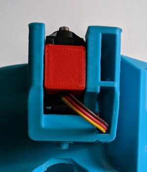 Insert a servo stopper (shown in red) and secure with 1.5" screws.